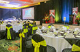 Exit Reality event with black chair covers and green sashes