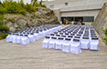 Outdoor party with white covered chairs dn black sashes