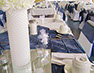 White tablecloths with blue accents and white towering centrepieces