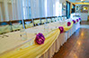 Party event with yellow chair sashes and white tablecloths