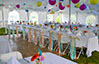 Decorated party tent with chair streamers and flowers