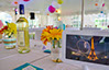 Party event with wine, multi-coloured flowers and tablet showing Eiffel tower